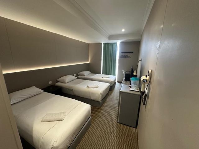 Li Garden Hotel guest room with multiple beds