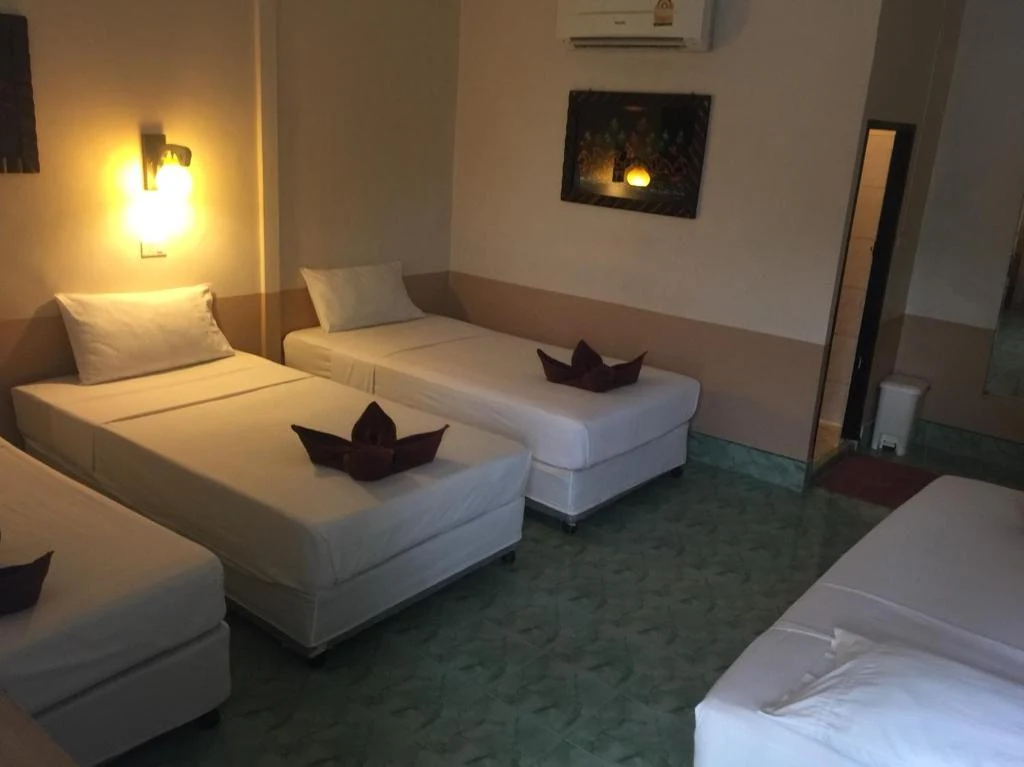 Coco's Guest House multi-bed room with air conditioning