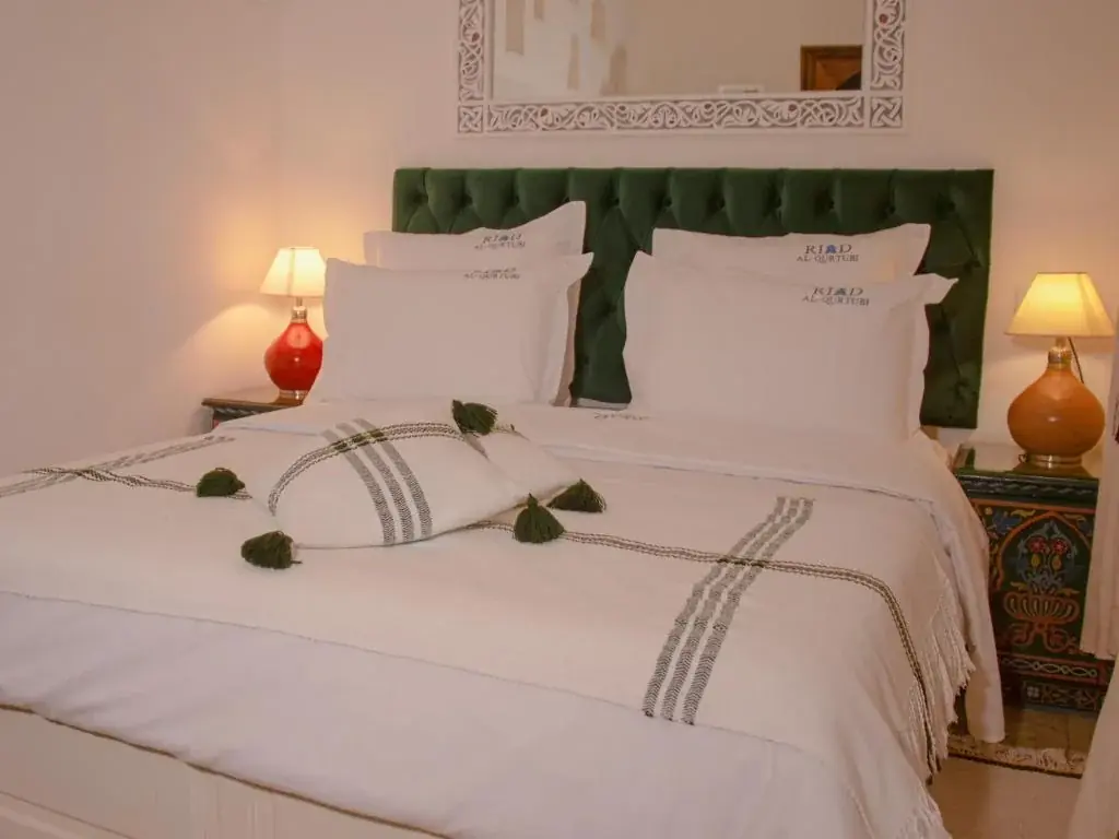 Double room with green upholstered headboard at Riad Al-Qurtubi Tangier