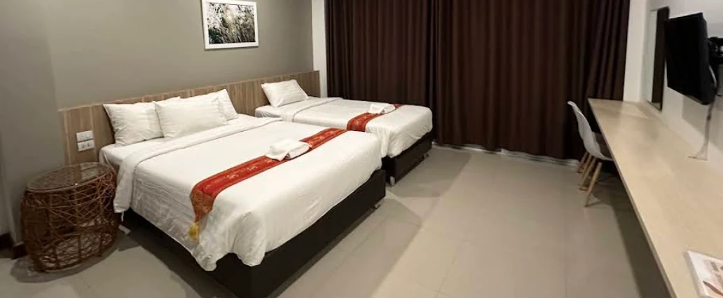 Vieng Khong Hotel triple room with comfortable beds and modern interior