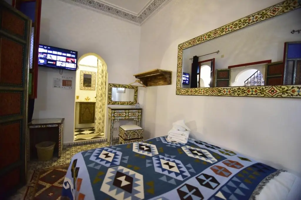 Double room with blue patterned bedding at Zoco Riad