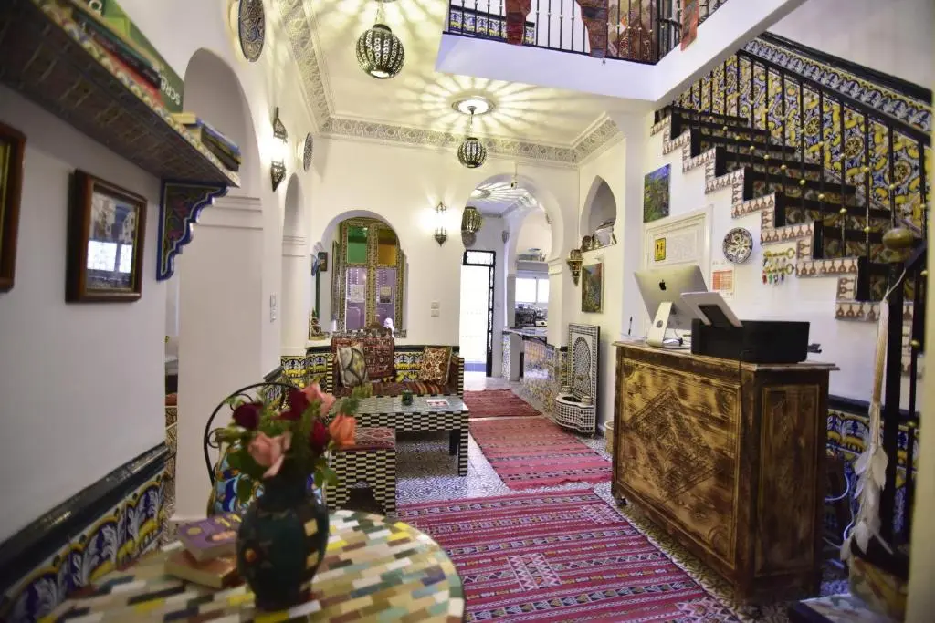 Reception lobby with colorful Moroccan tiles at Zoco Riad